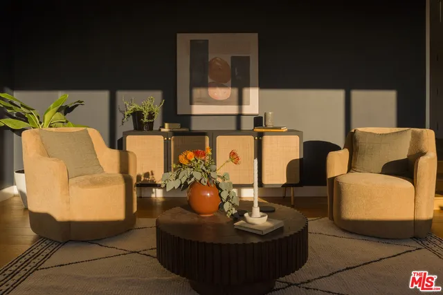 a living room with furniture and a lamp