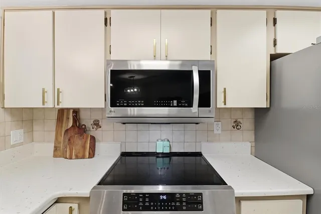 a kitchen with a stove and a microwave