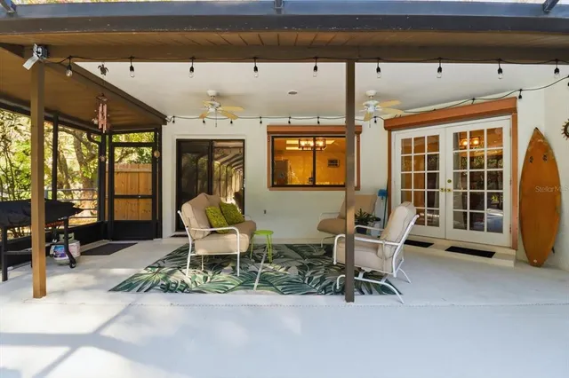 a building outdoor space with patio furniture and potted plants