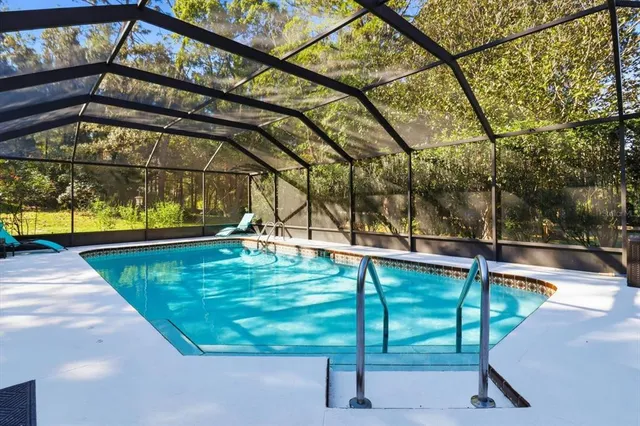 a view of swimming pool with an outdoor seating