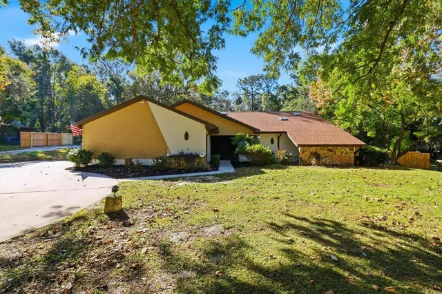 a backyard of a house with yard and outdoor seating