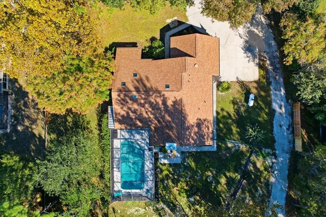 an aerial view of a house with a yard and garden
