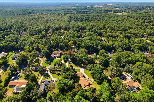 an aerial view of a houses with a yard