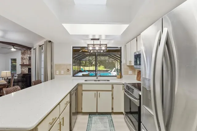 a kitchen with a sink appliances and cabinets