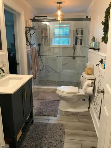 a bathroom with a sink toilet and shower