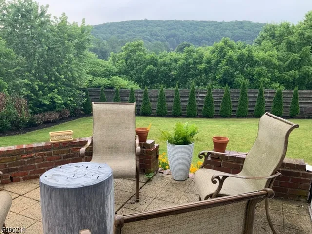 a view of a chairs and table in the backyard
