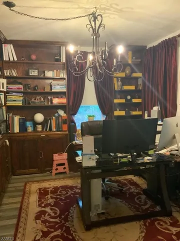 a living room with furniture a window and a chandelier