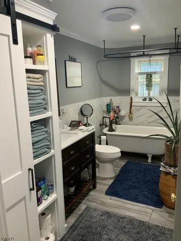 a kitchen with stainless steel appliances kitchen island granite countertop a refrigerator oven a sink with dishwasher and wooden cabinets