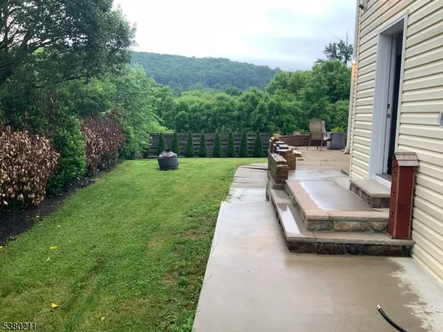 a view of a backyard with sitting area