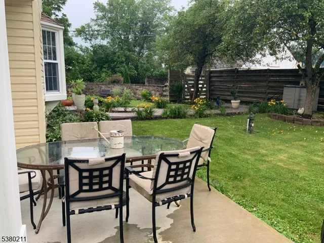 a view of a chairs and table in patio with a yard