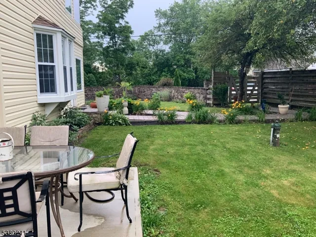 a view of backyard of house with seating space