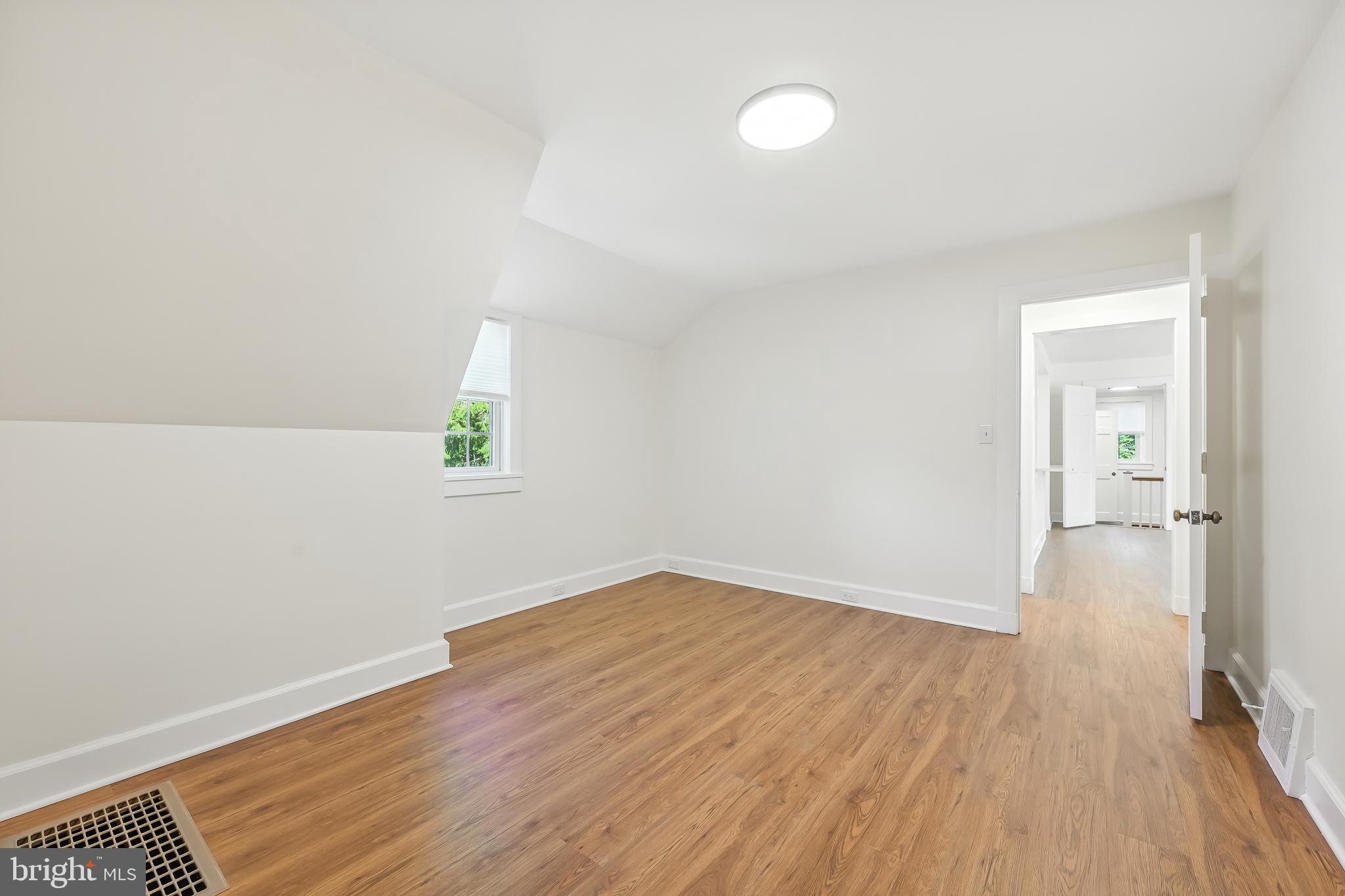 22 Center Meeting Road, Unit B Wilmington, DE 19807 - Photo 11 of 20 an empty room with wooden floor and windows