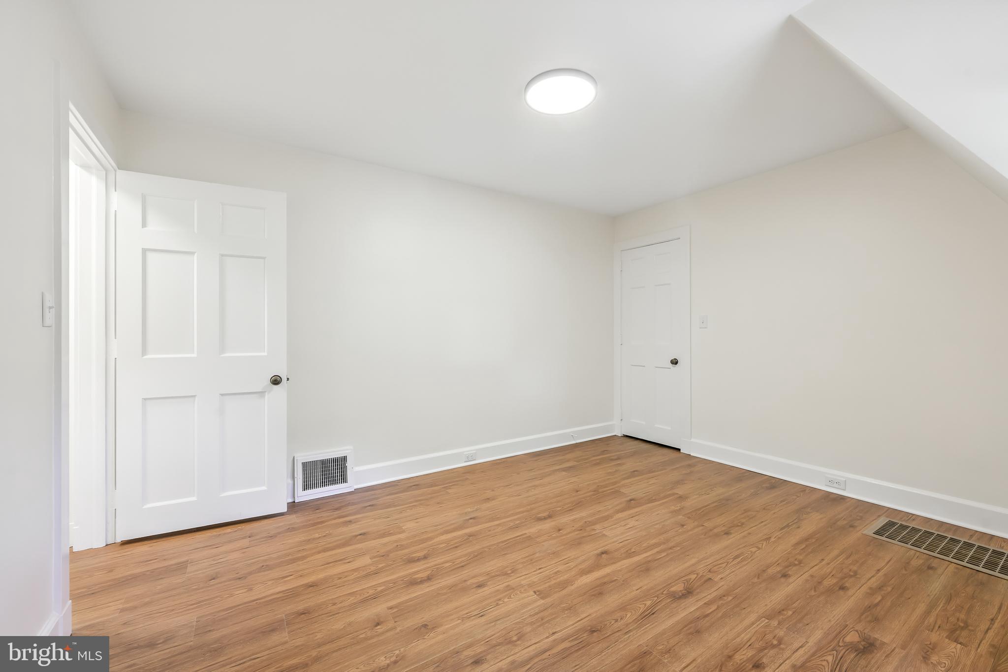 22 Center Meeting Road, Unit B Wilmington, DE 19807 - Photo 15 of 20 a view of an empty room with wooden floor