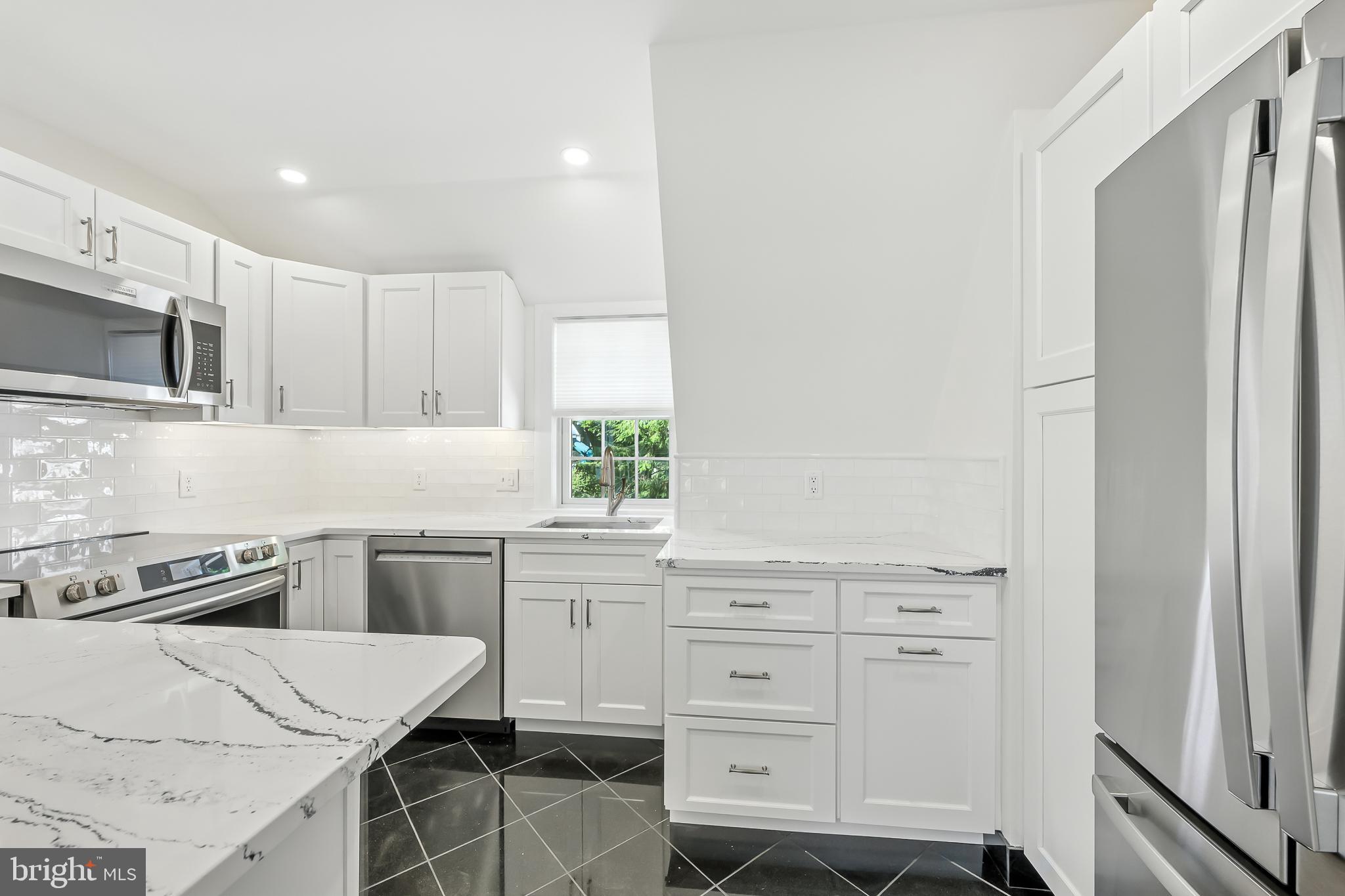 22 Center Meeting Road, Unit B Wilmington, DE 19807 - Photo 4 of 20 a kitchen with white cabinets and appliances