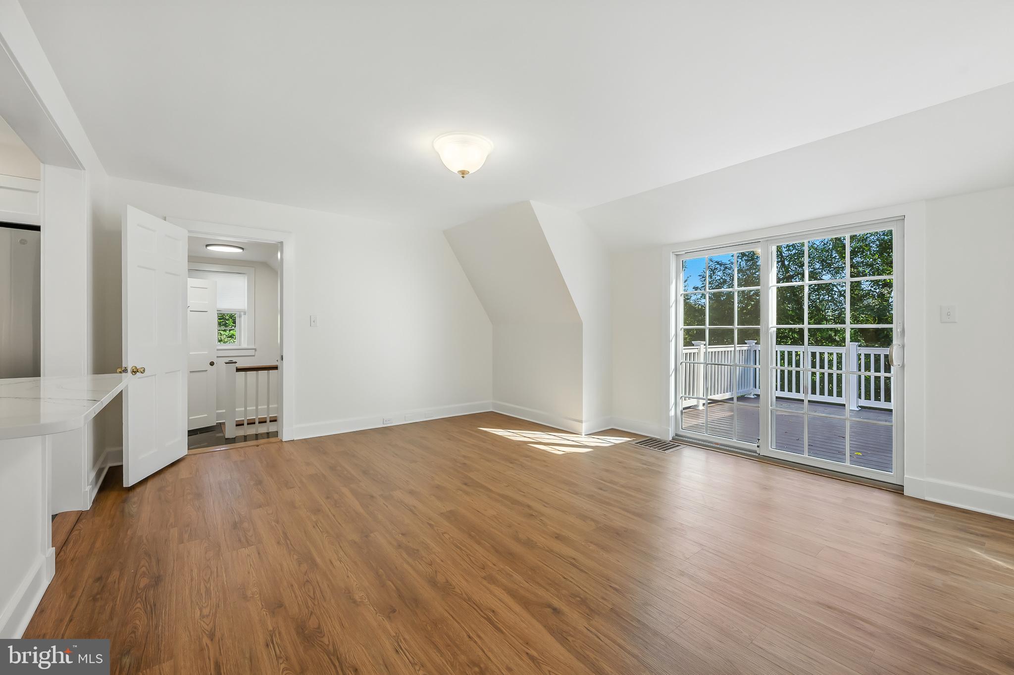 22 Center Meeting Road, Unit B Wilmington, DE 19807 - Photo 7 of 20 wooden floor in an empty room with a window