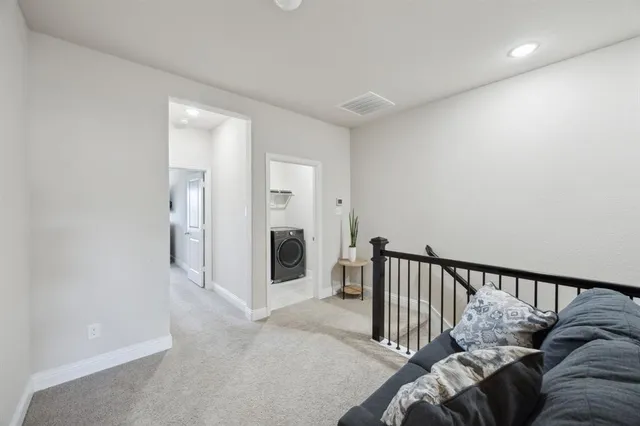 a bedroom with a bed a chandelier and a window