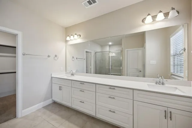a bathroom with a glass shower door