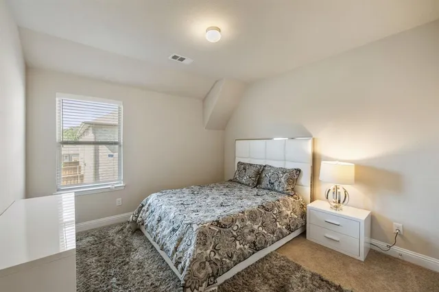 a bathroom with a double vanity sink a toilet and a mirror