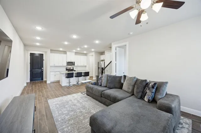 a living room with furniture and kitchen view