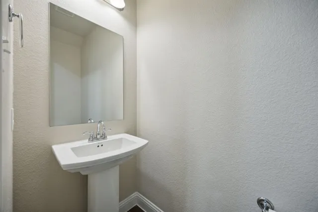 a bathroom with a sink and mirror