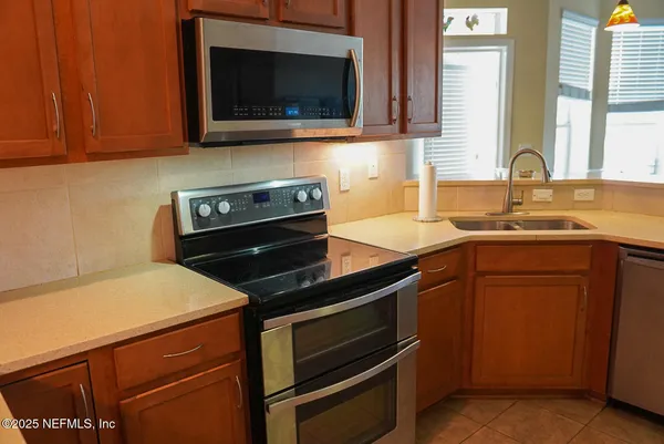 a kitchen with a stove and a microwave oven