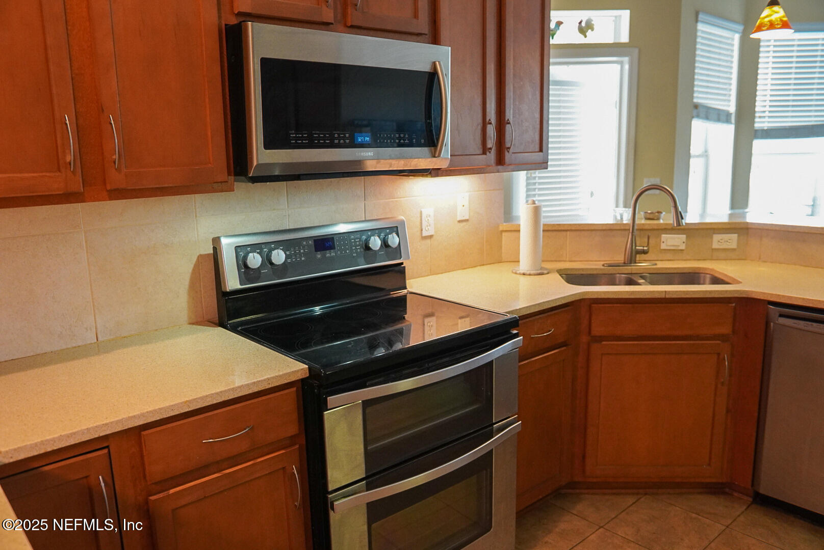 830 East Red House Branch Road St. Augustine, FL 32084 - Photo 11 of 25 a kitchen with a stove and a microwave oven
