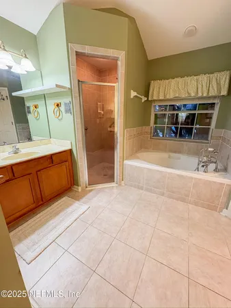 a spacious bathroom with a tub and shower