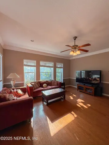 a living room with furniture ceiling fan and a rug