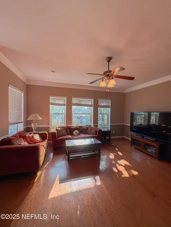 a living room with furniture and a flat screen tv