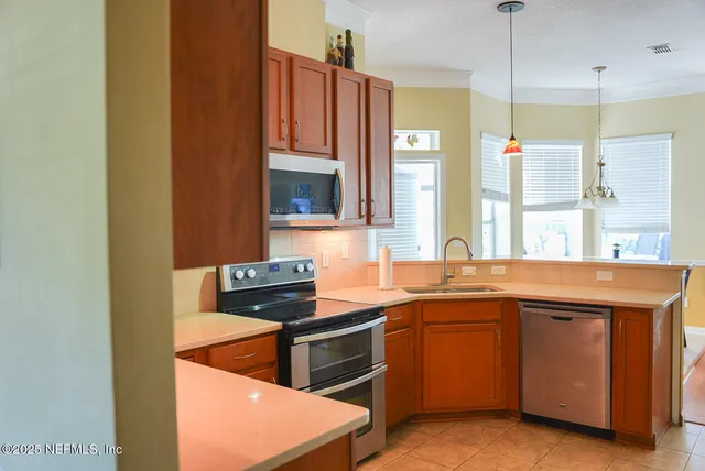 a kitchen that has a sink and a stove in it