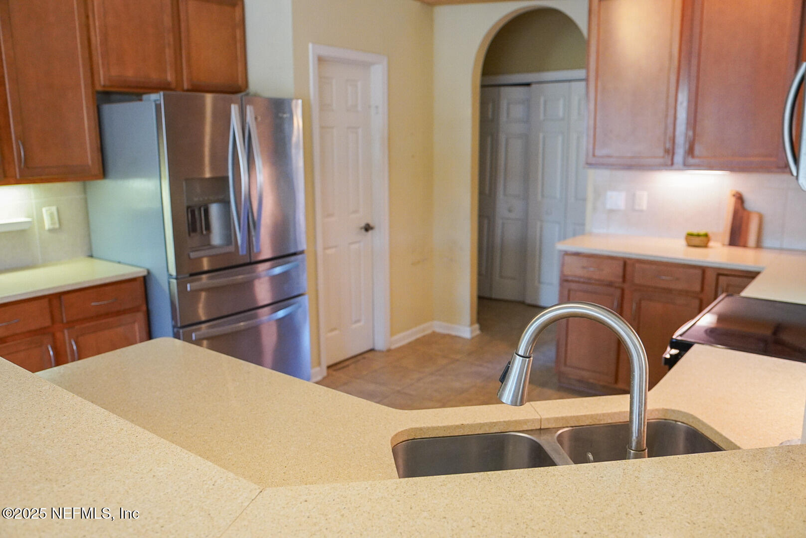 830 East Red House Branch Road St. Augustine, FL 32084 - Photo 9 of 25 a kitchen with stainless steel appliances kitchen island a sink a refrigerator and cabinets