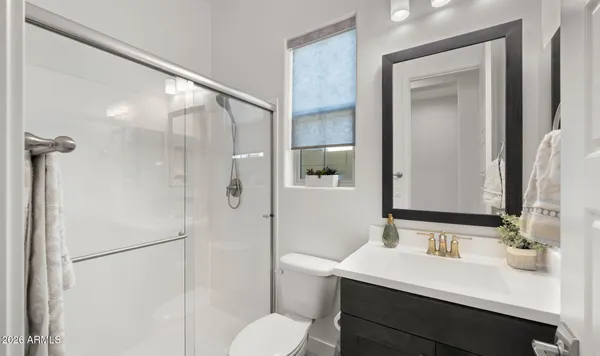 a bathroom with a sink vanity and toilet
