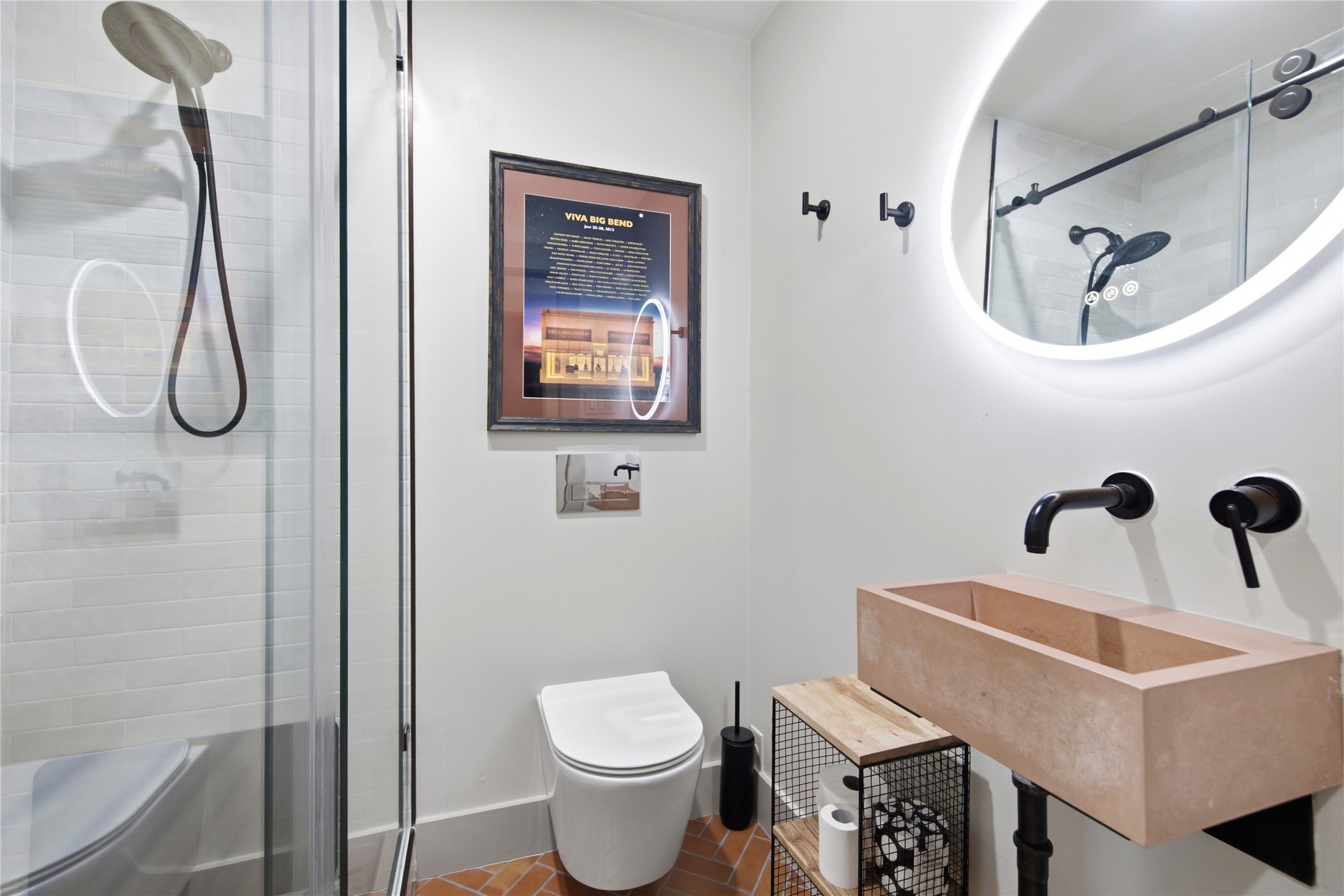 5600 Ledesma Road Austin, TX 78721 - Photo 16 of 36 A modern bathroom showcases a floating concrete basin sink and tile flooring.