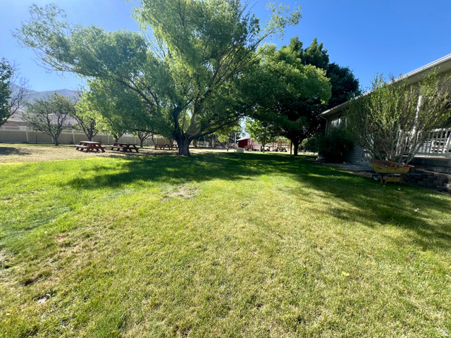 812 East Bates Cyn Road Tooele, UT 84074 - Photo 132 of 144 Expansive green lawn with mature shade trees and mountain backdrop
