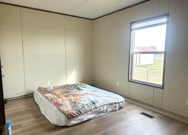 a bedroom with a bed and a window