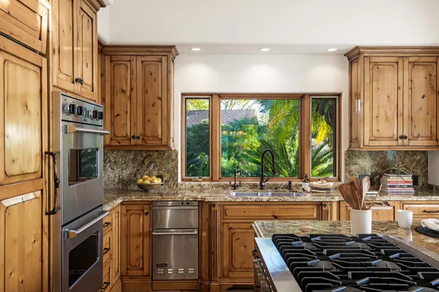 a kitchen with stainless steel appliances a sink and a stove