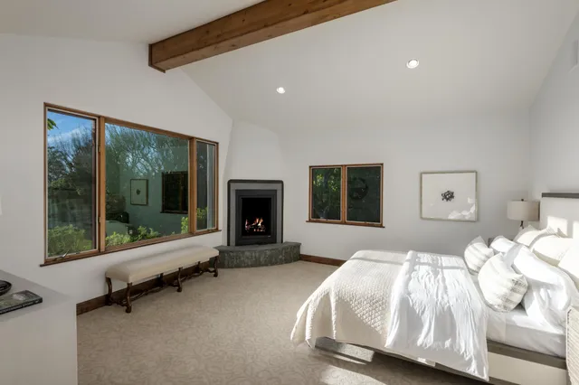 a spacious bedroom with a bed and a fireplace