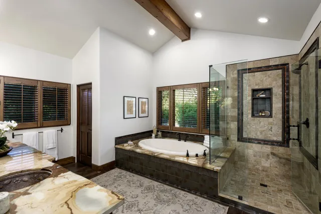 a bathroom with bathtub and a shower