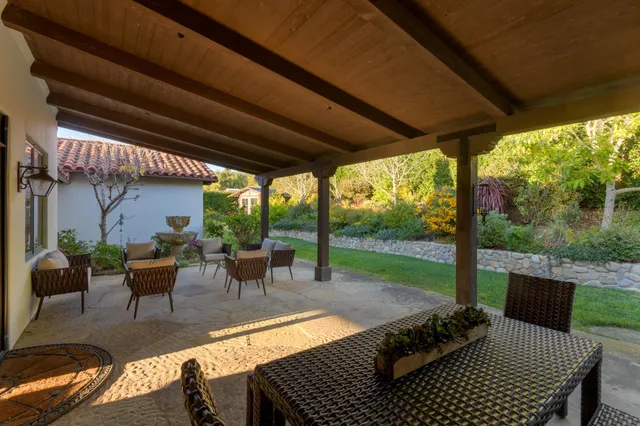 a view of a porch with furniture and garden