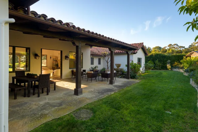 a view of a house with backyard porch and sitting area