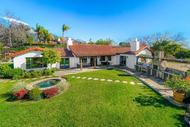 a house with swimming pool in front of it