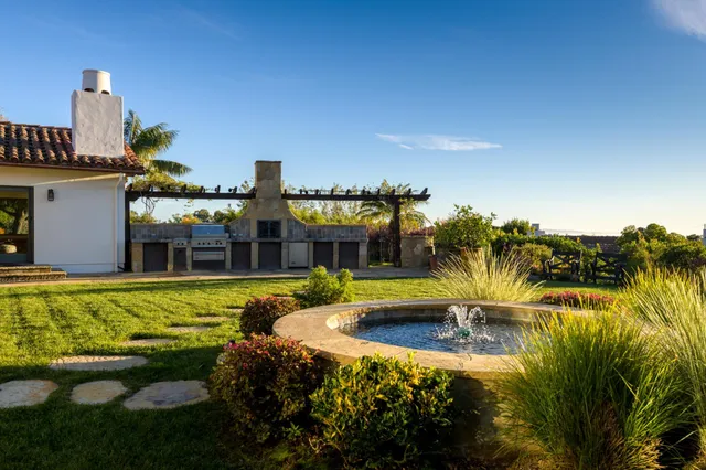 a swimming pool with outdoor seating yard and barbeque oven