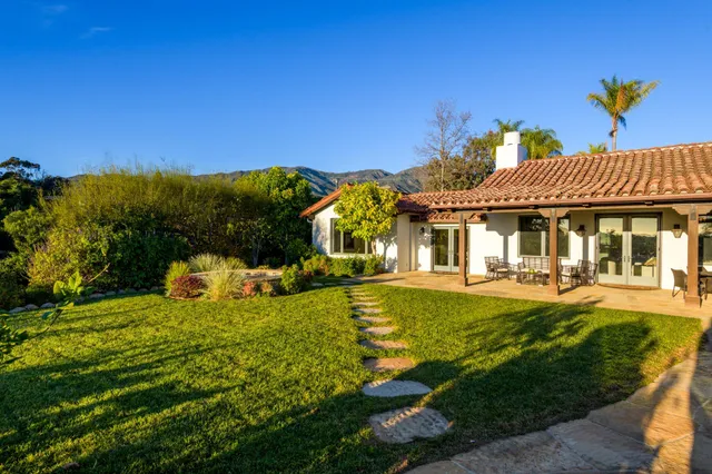 a front view of a house with swimming pool having outdoor seating