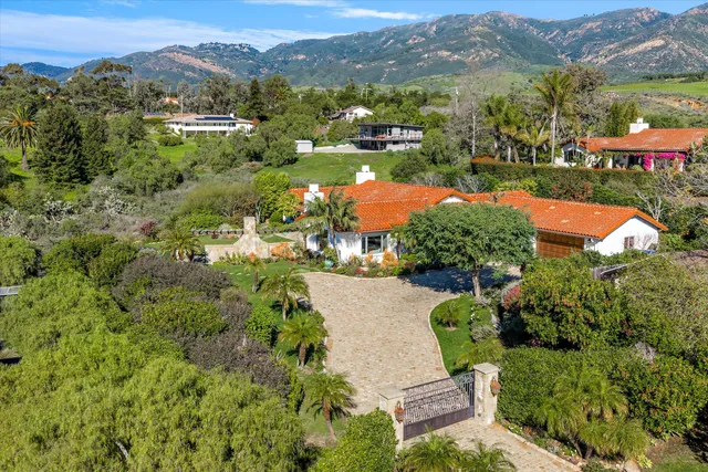 an aerial view of residential houses with outdoor space and street view