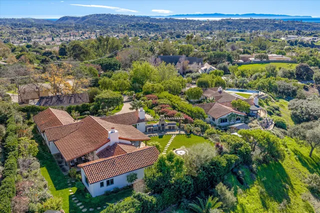 an aerial view of residential houses with outdoor space and river