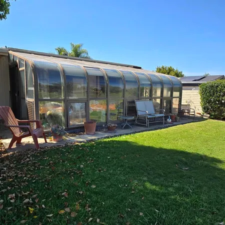 a view of a house with backyard porch and sitting area