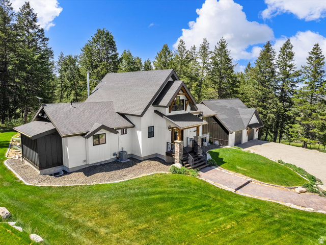1225 Old Oregon Road Soda Springs, ID 83276 - Photo 54 of 67 Contemporary home featuring a gabled roofline, mixed exterior siding, a covered entry porch, a multi-car garage, and a gravel driveway