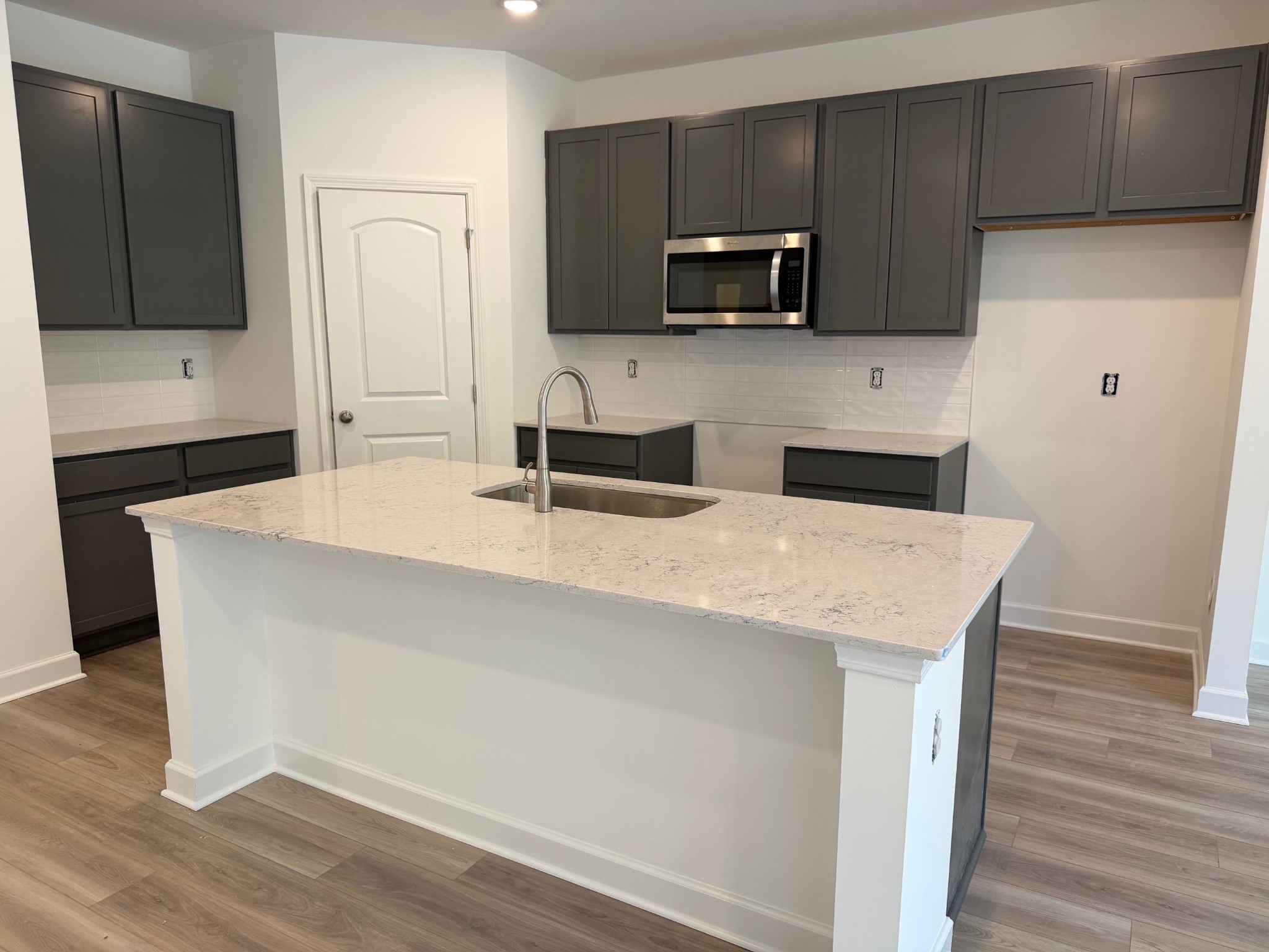 2367 Beverly Gail Road Pleasant View, TN 37146 - Photo 2 of 42 a kitchen with stainless steel appliances a microwave a sink and cabinets
