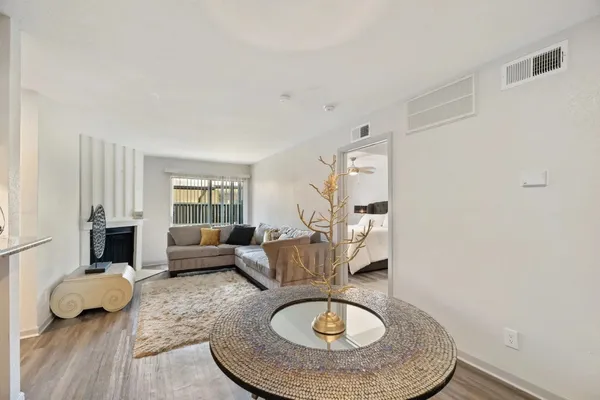 a living room with furniture and a wooden floor
