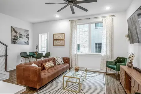 a living room with furniture and a large window